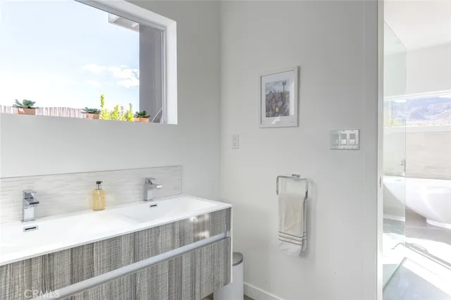 a bathroom with a glass door shower