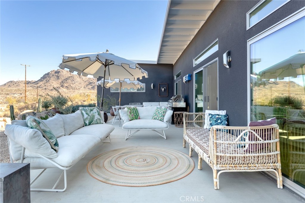 7802 Quail Springs Road Joshua Tree, CA 92252 - Photo 24 of 46 a outdoor space with patio the couches and a potted plant on the table