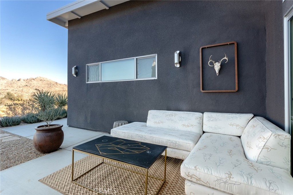 7802 Quail Springs Road Joshua Tree, CA 92252 - Photo 25 of 46 a living room with furniture and a rug