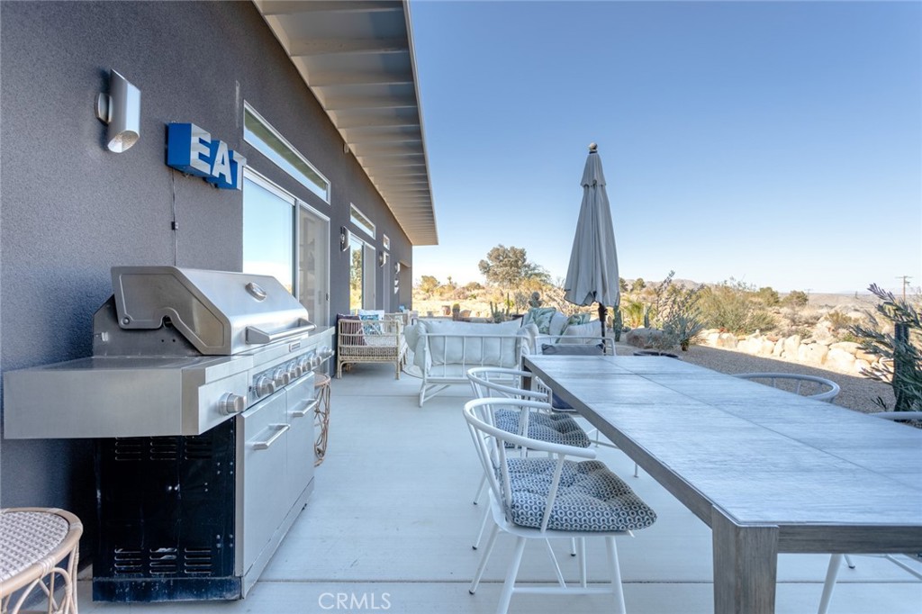 7802 Quail Springs Road Joshua Tree, CA 92252 - Photo 29 of 46 a living room with furniture and a flat screen tv