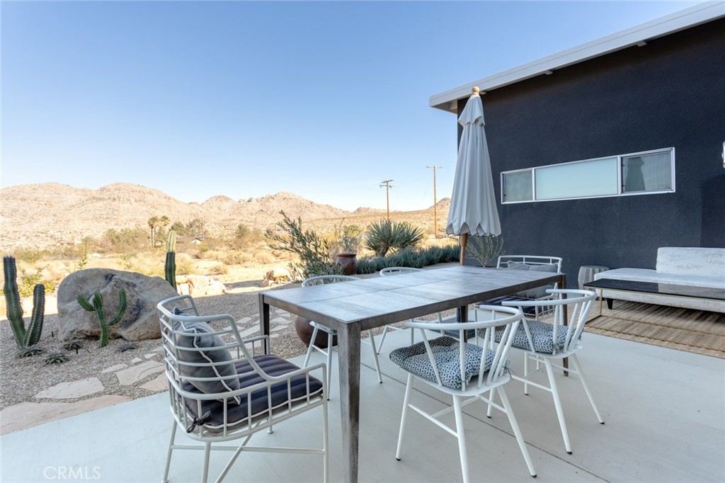 7802 Quail Springs Road Joshua Tree, CA 92252 - Photo 30 of 46 a terrace of a house with table and chairs