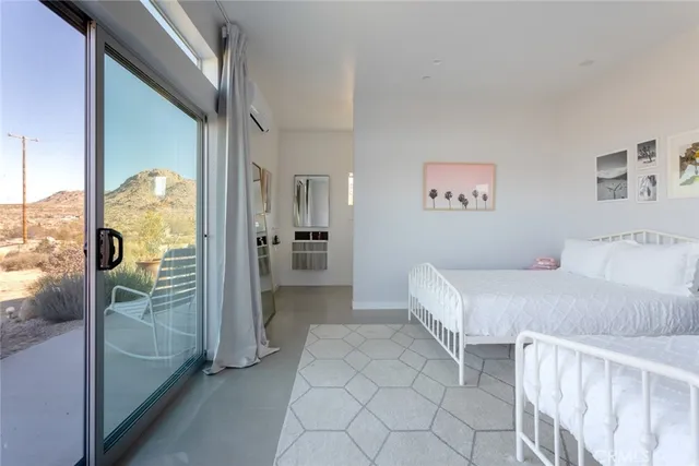 a bedroom with a bed and wall painting