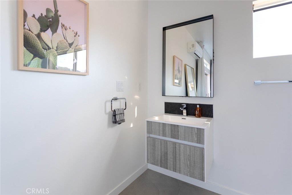 7802 Quail Springs Road Joshua Tree, CA 92252 - Photo 36 of 46 a bathroom with a sink a mirror and a vanity