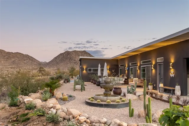 a view of a patio with dining table and chairs with wooden fence