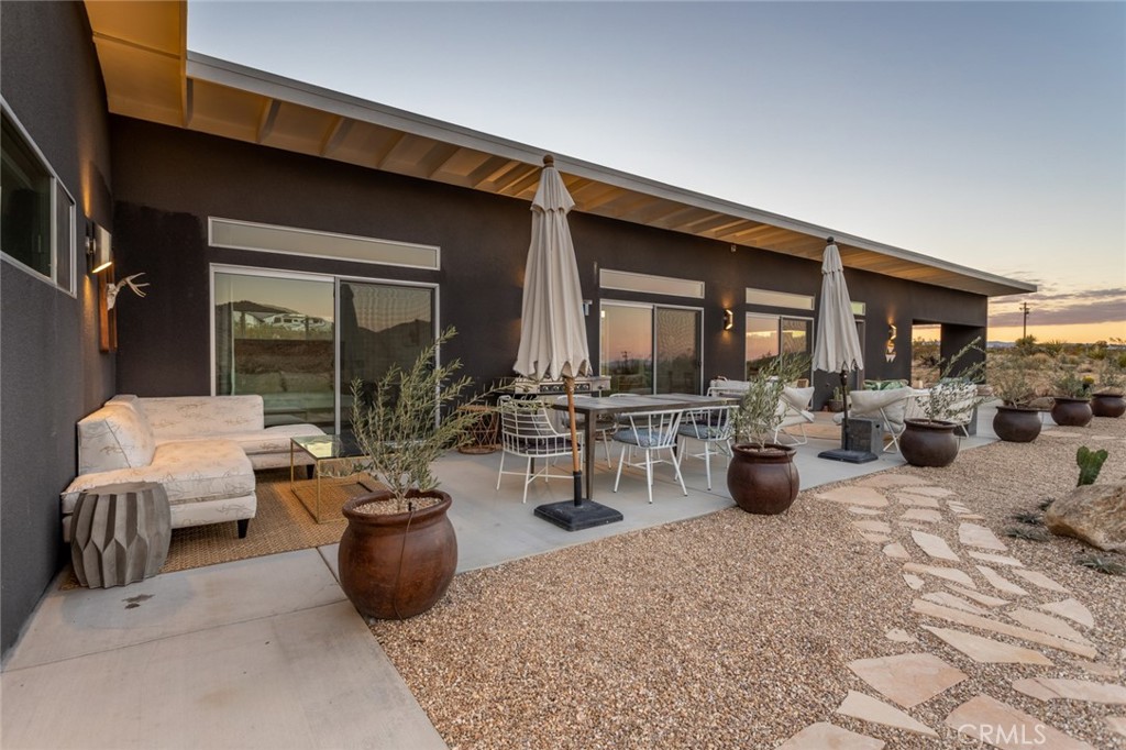 7802 Quail Springs Road Joshua Tree, CA 92252 - Photo 45 of 46 a view of a patio with dining table and chairs