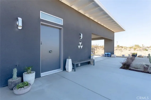 a dining room with stainless steel appliances kitchen island granite countertop a dining table chairs and a refrigerator