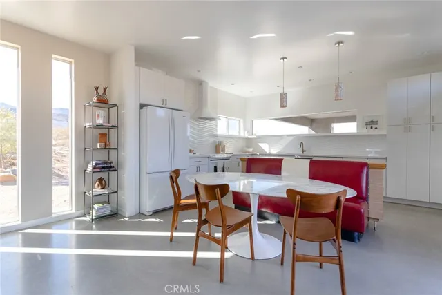 a kitchen with stainless steel appliances granite countertop a sink a stove and a refrigerator