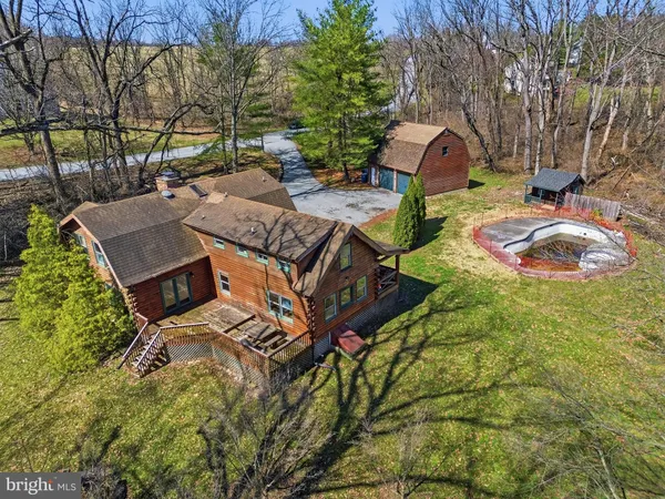 an aerial view of a house with garden space and street view