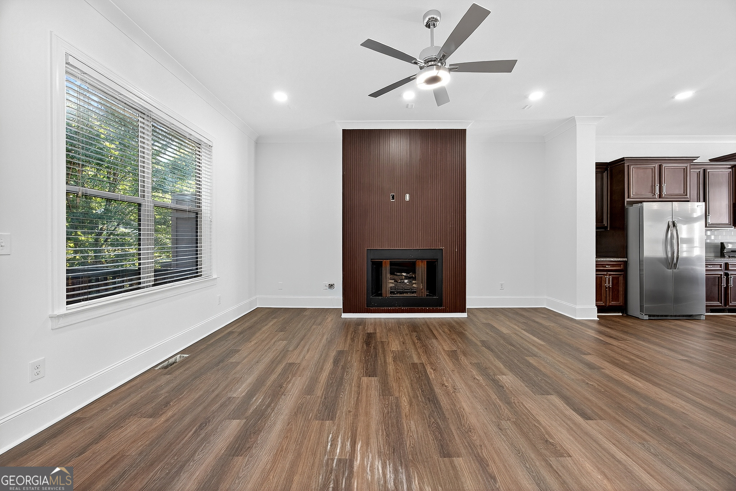 712 Avondale Hills Drive Decatur, GA 30032 - Photo 11 of 29 a view of empty room with wooden floor and fireplace