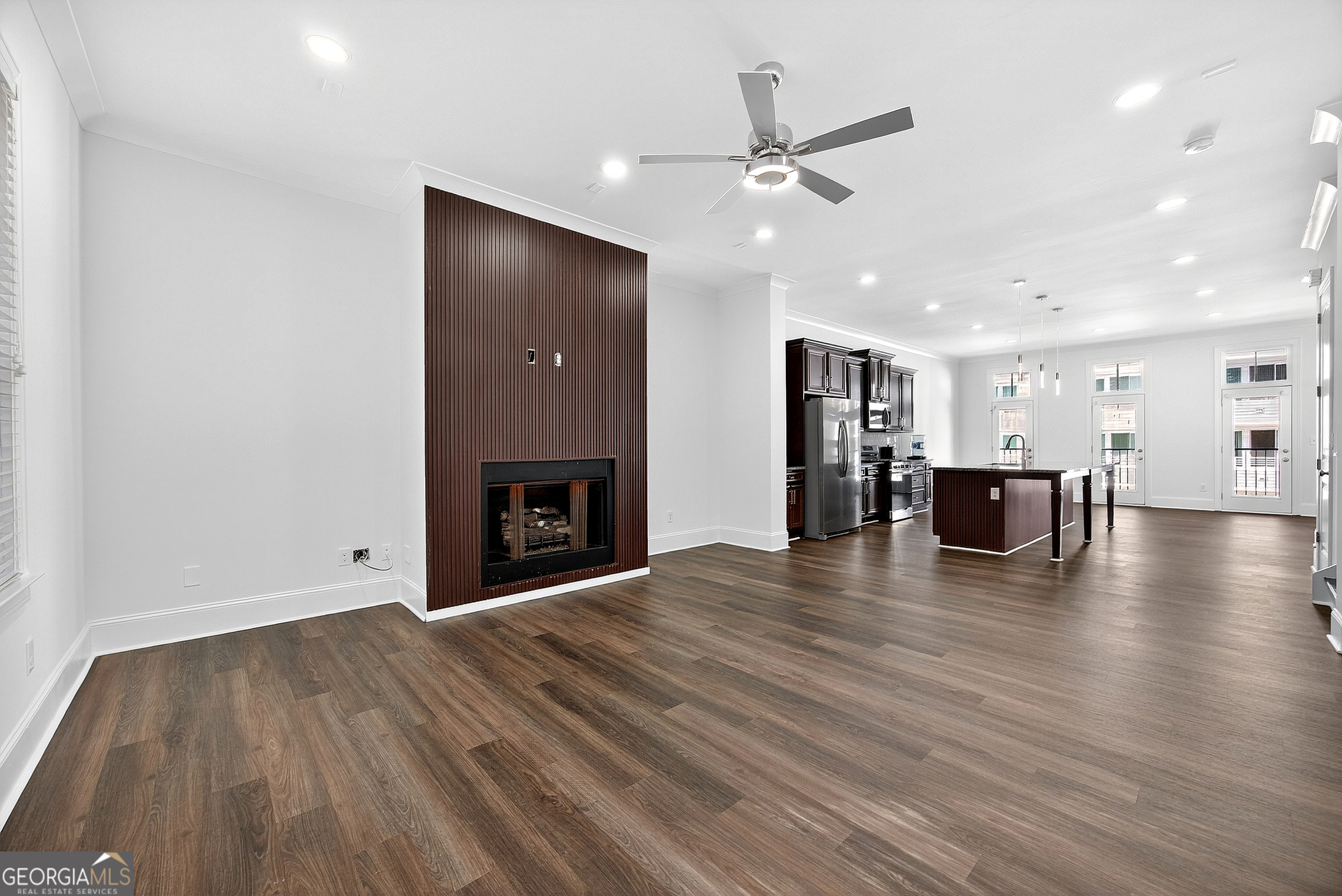 712 Avondale Hills Drive Decatur, GA 30032 - Photo 13 of 29 a view of a livingroom with a fireplace a ceiling fan and kitchen view