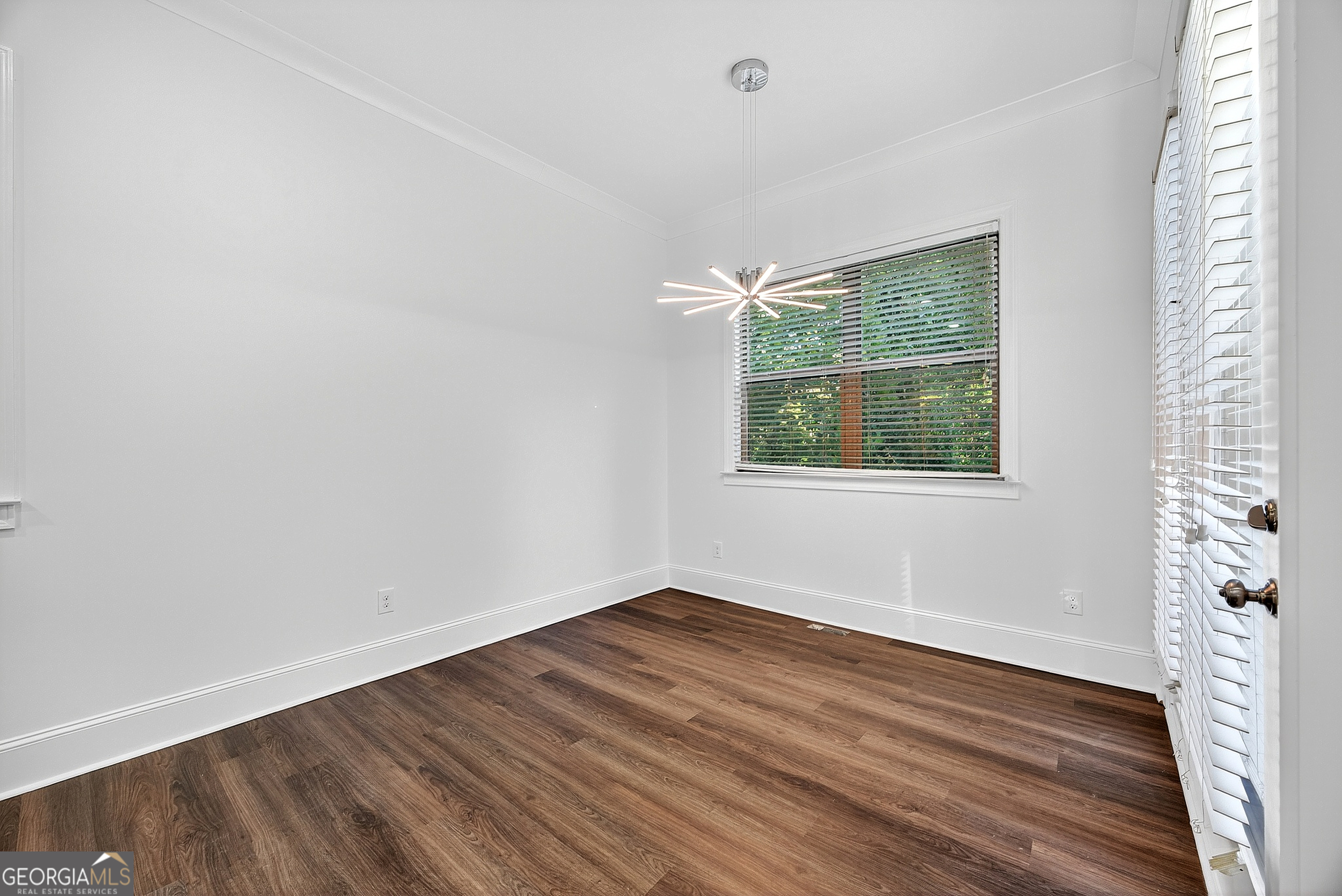 712 Avondale Hills Drive Decatur, GA 30032 - Photo 14 of 29 wooden floor in an empty room with a window