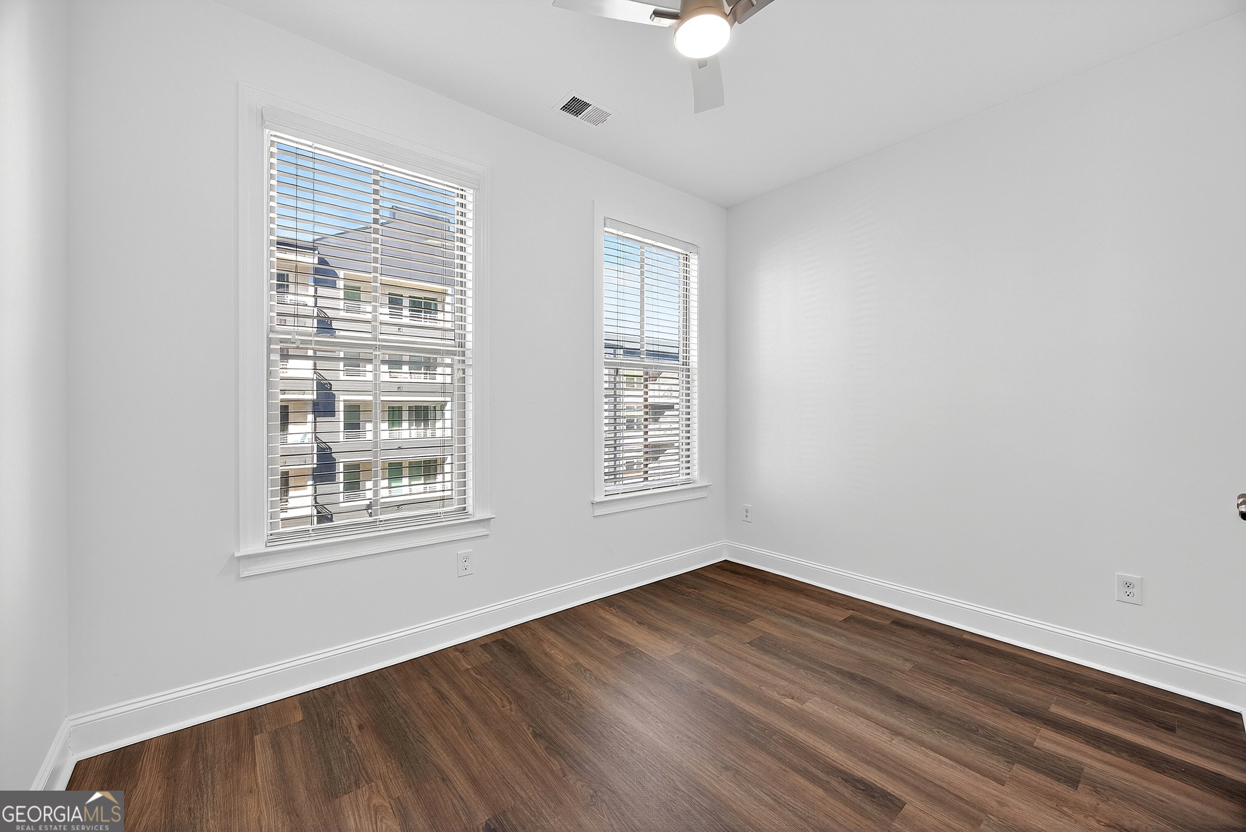 712 Avondale Hills Drive Decatur, GA 30032 - Photo 17 of 29 an empty room with wooden floor and windows