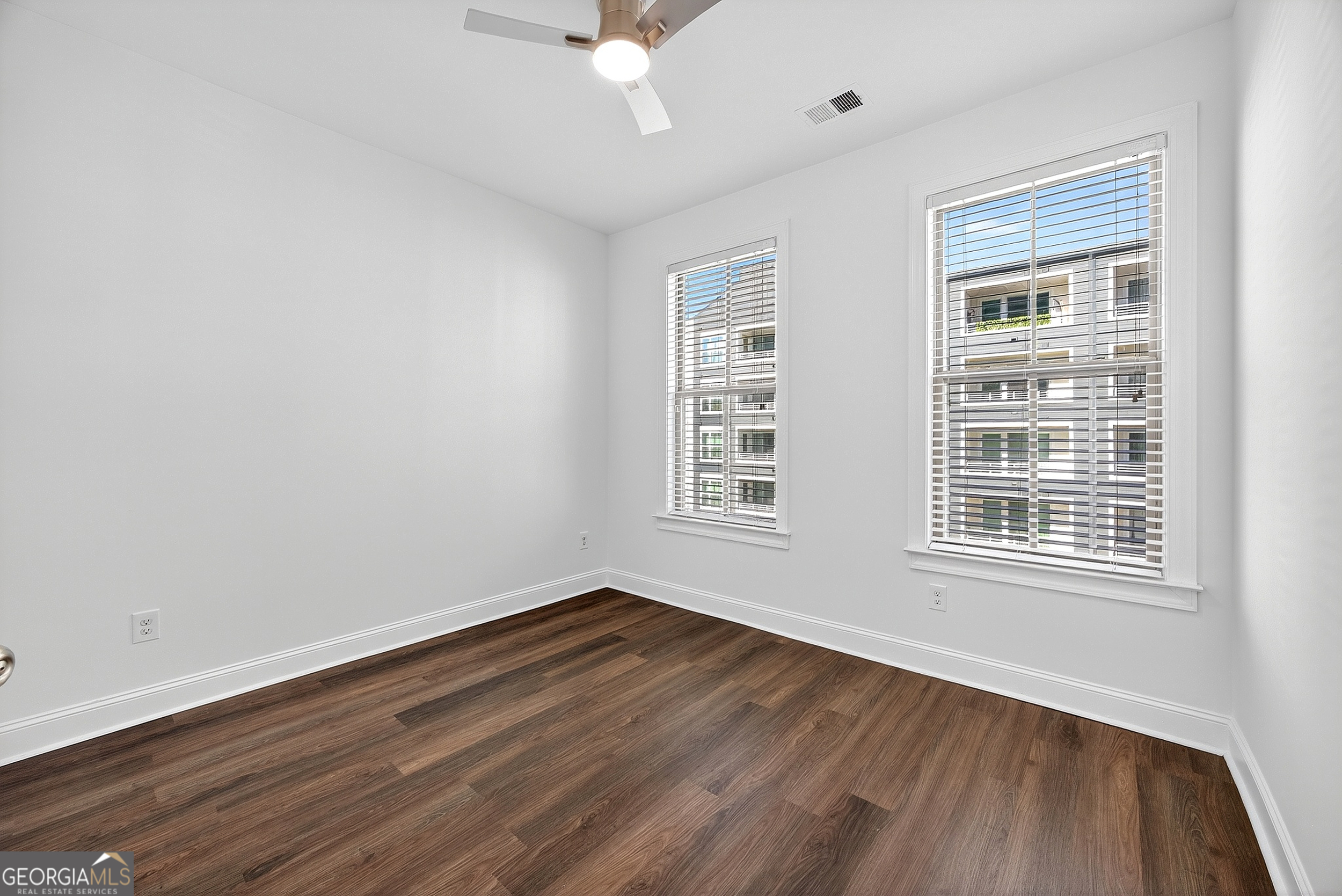 712 Avondale Hills Drive Decatur, GA 30032 - Photo 18 of 29 a view of an empty room with wooden floor and a window