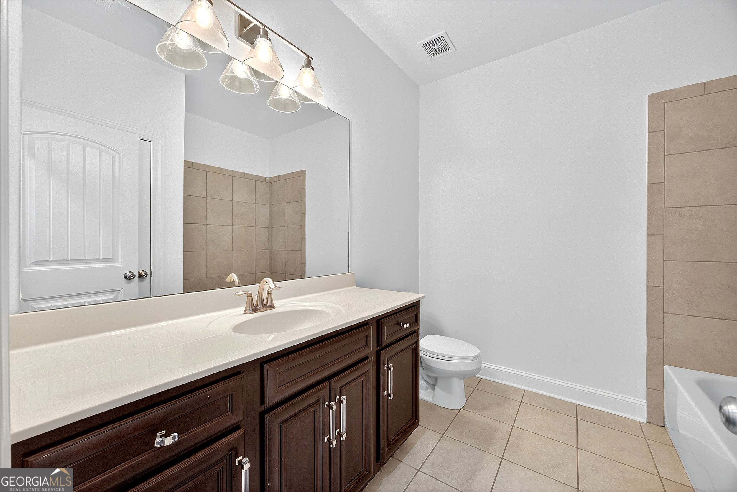 712 Avondale Hills Drive Decatur, GA 30032 - Photo 19 of 29 a bathroom with a sink a toilet a mirror and shower