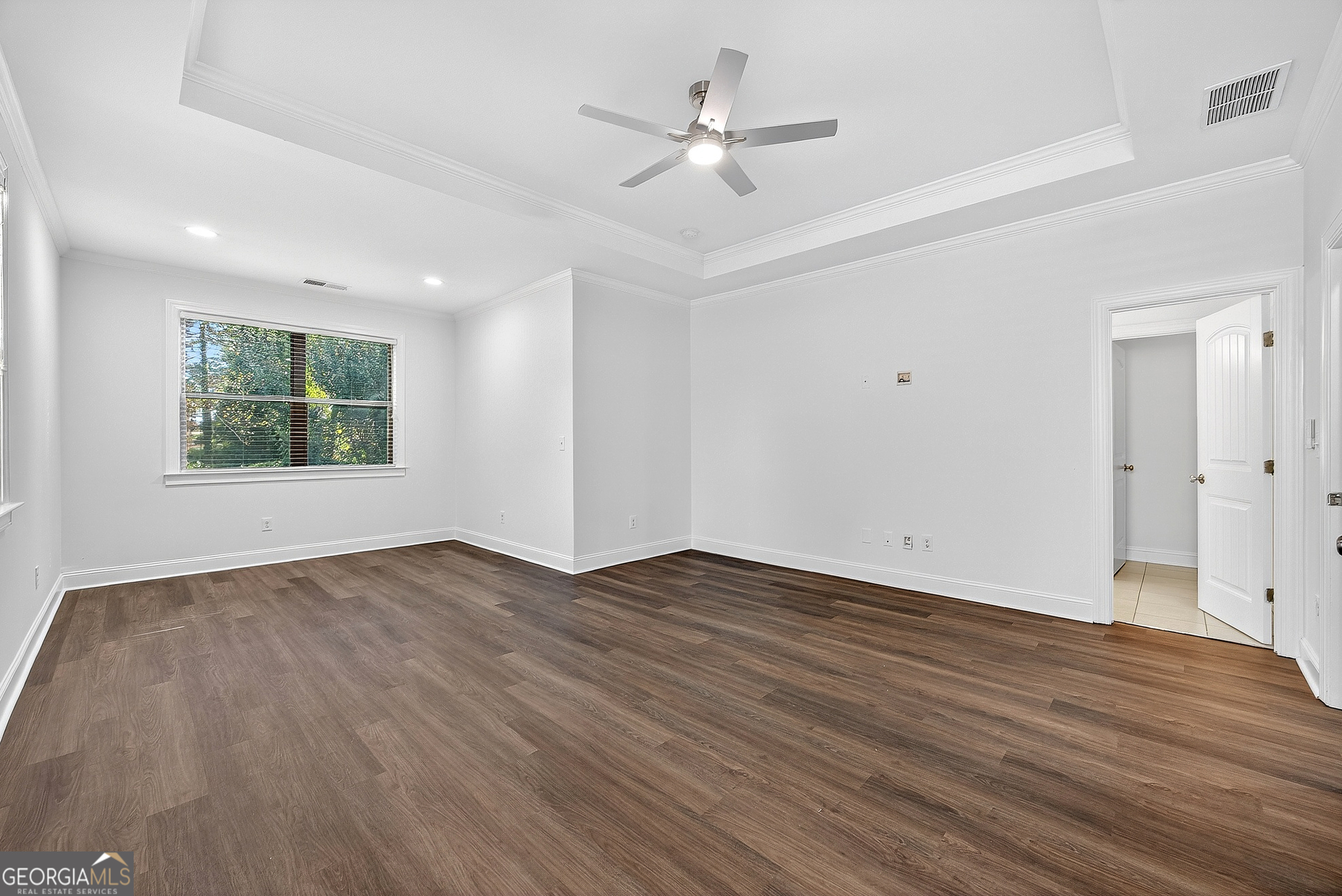 712 Avondale Hills Drive Decatur, GA 30032 - Photo 23 of 29 a view of an empty room with wooden floor and a window