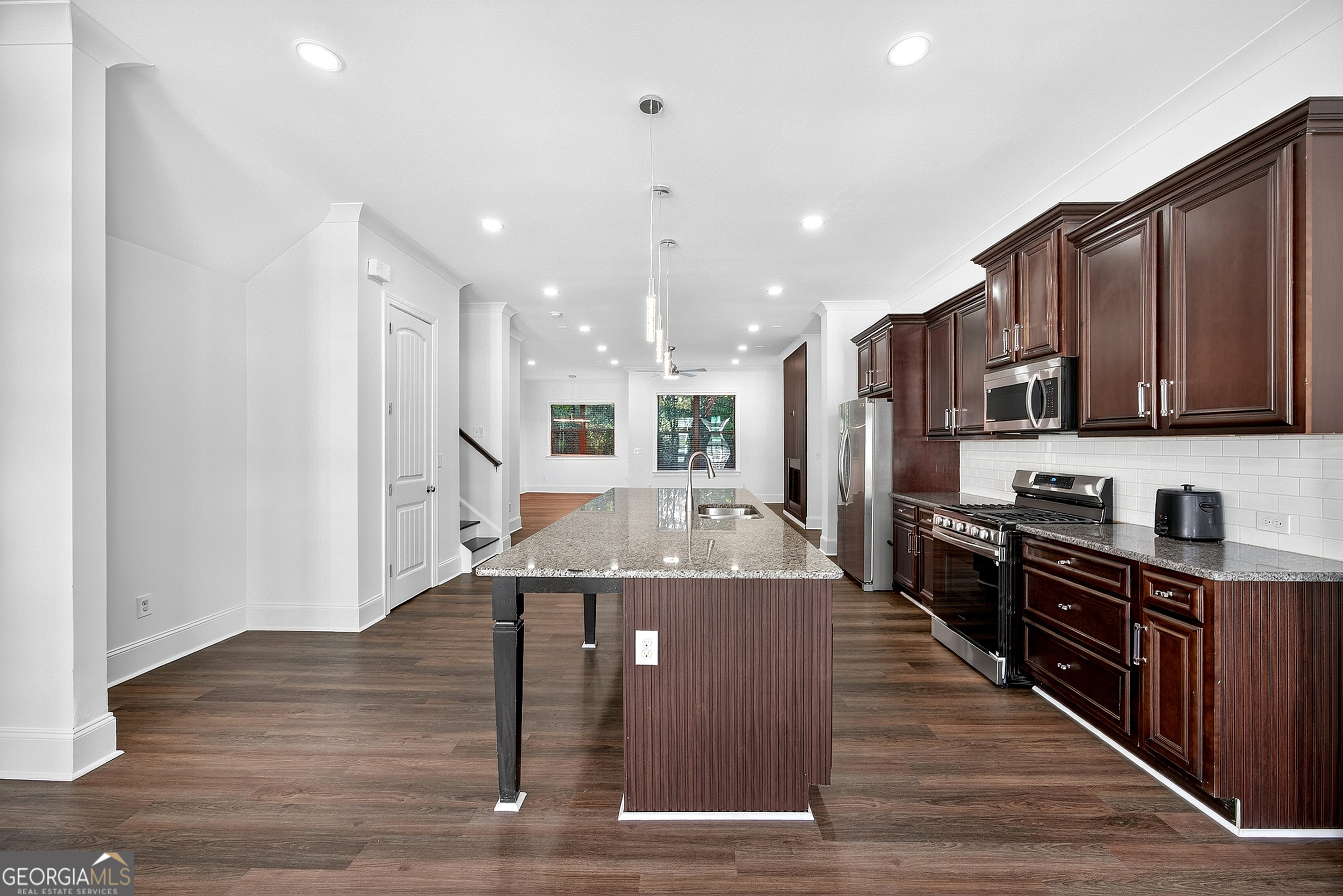 712 Avondale Hills Drive Decatur, GA 30032 - Photo 7 of 29 a kitchen with stainless steel appliances granite countertop a refrigerator a stove top oven a sink dishwasher and wooden cabinets with wooden floor