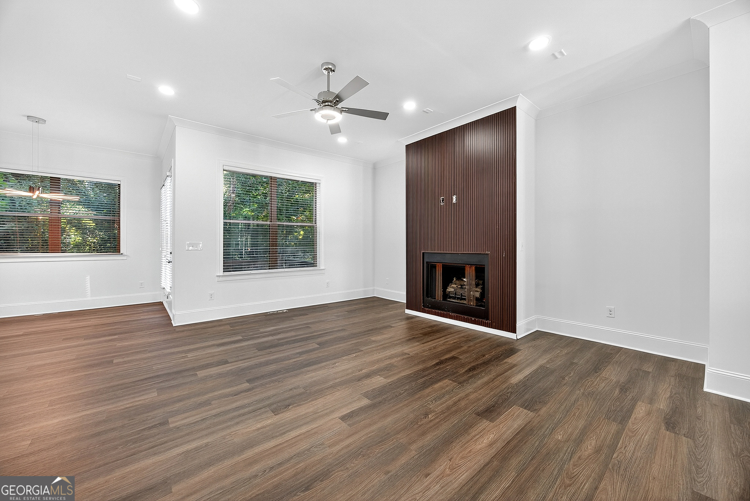 712 Avondale Hills Drive Decatur, GA 30032 - Photo 10 of 29 a view of an empty room with wooden floor fireplace and a window
