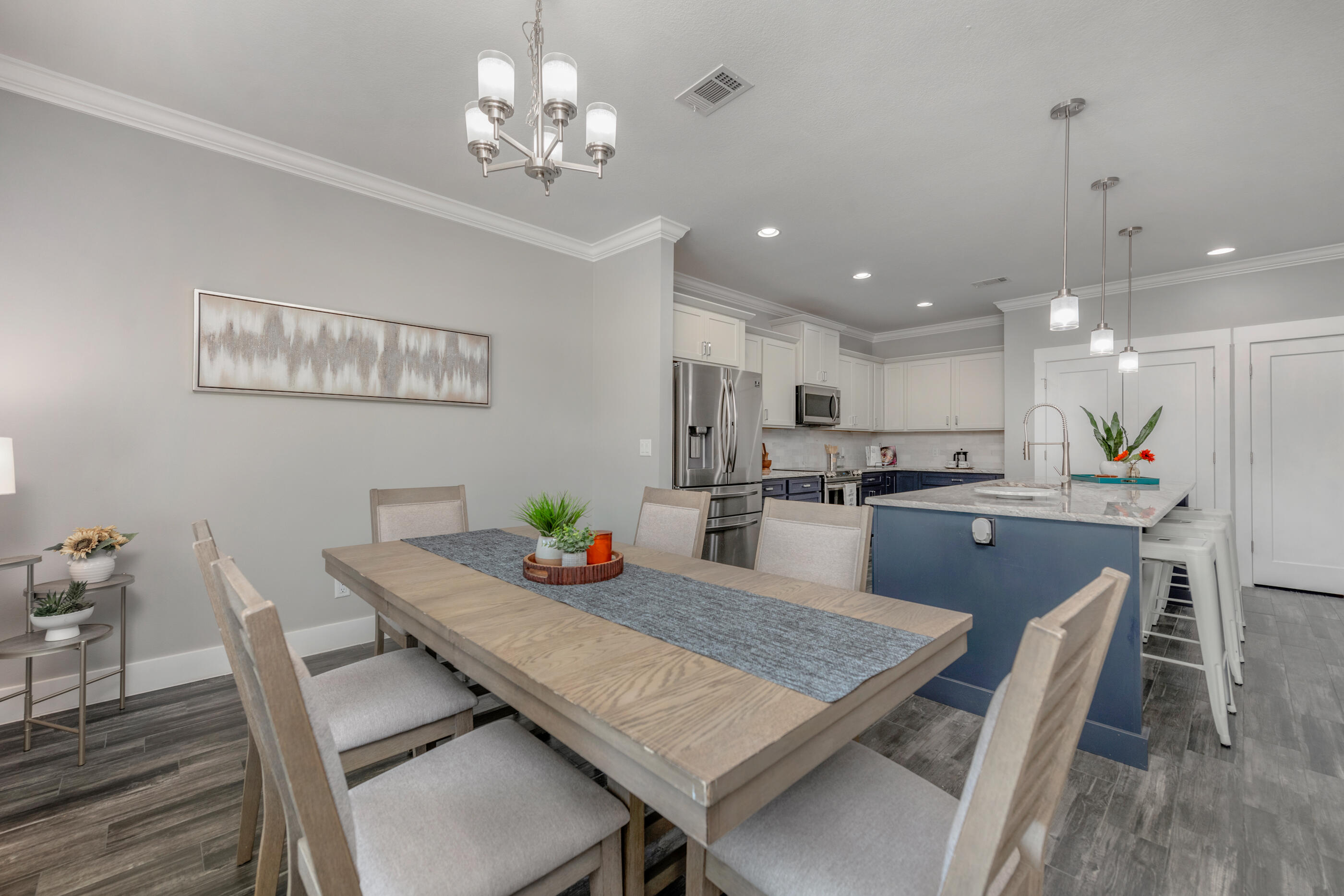 1504 West Ponderosa Road Fort Walton Beach, FL 32547 - Photo 15 of 51 a kitchen with a dining table chairs refrigerator and microwave