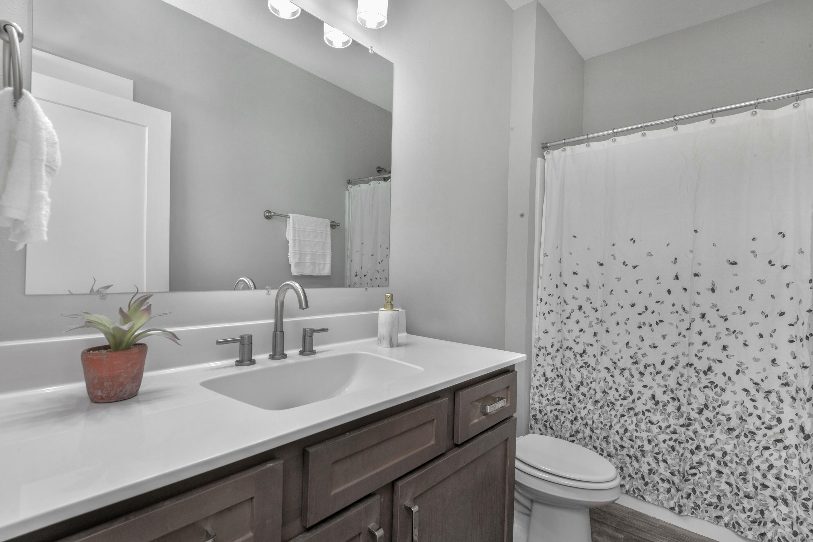 1504 West Ponderosa Road Fort Walton Beach, FL 32547 - Photo 38 of 51 a bathroom with a granite countertop sink a toilet and a mirror