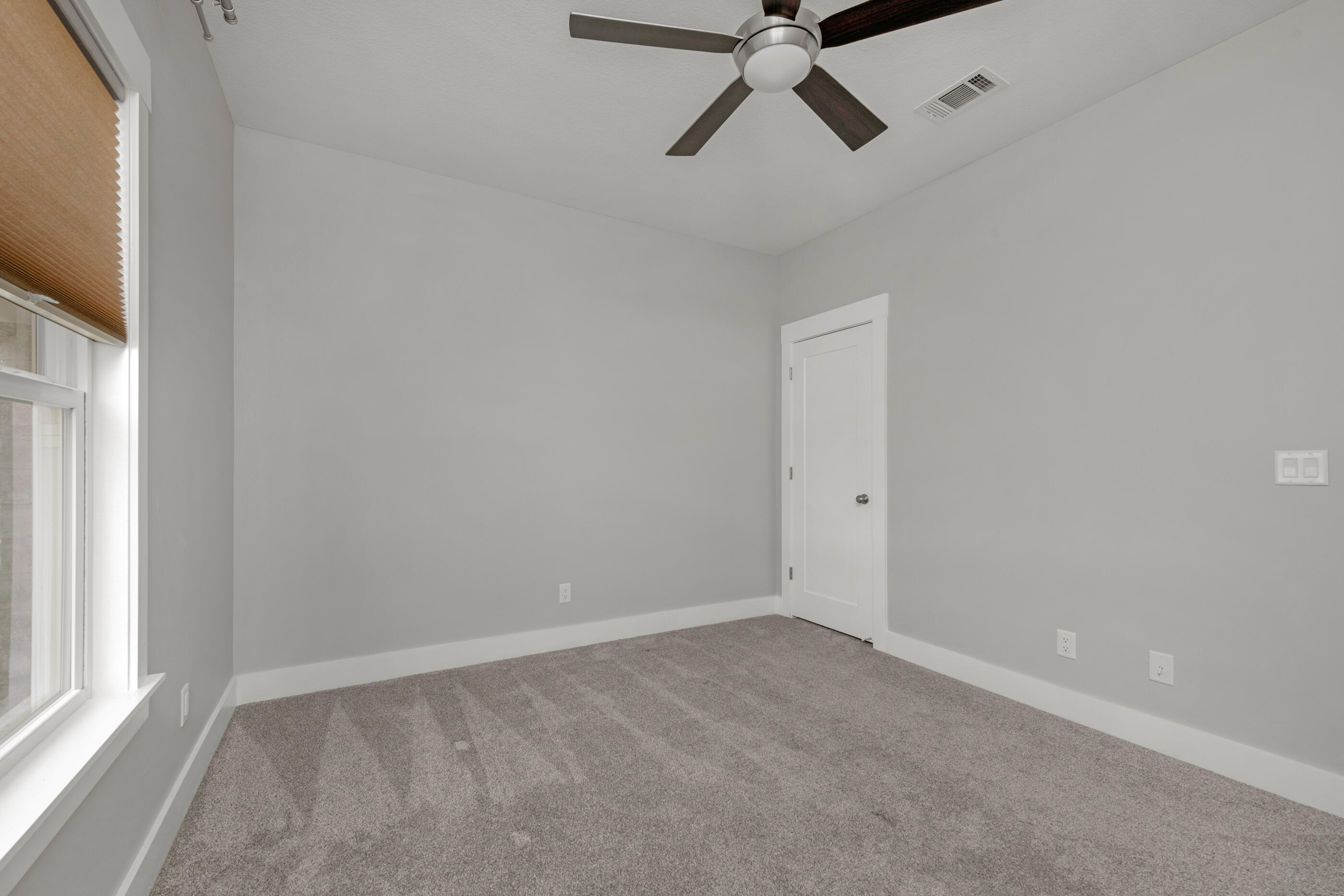 1504 West Ponderosa Road Fort Walton Beach, FL 32547 - Photo 46 of 51 an empty room with a ceiling fan and windows