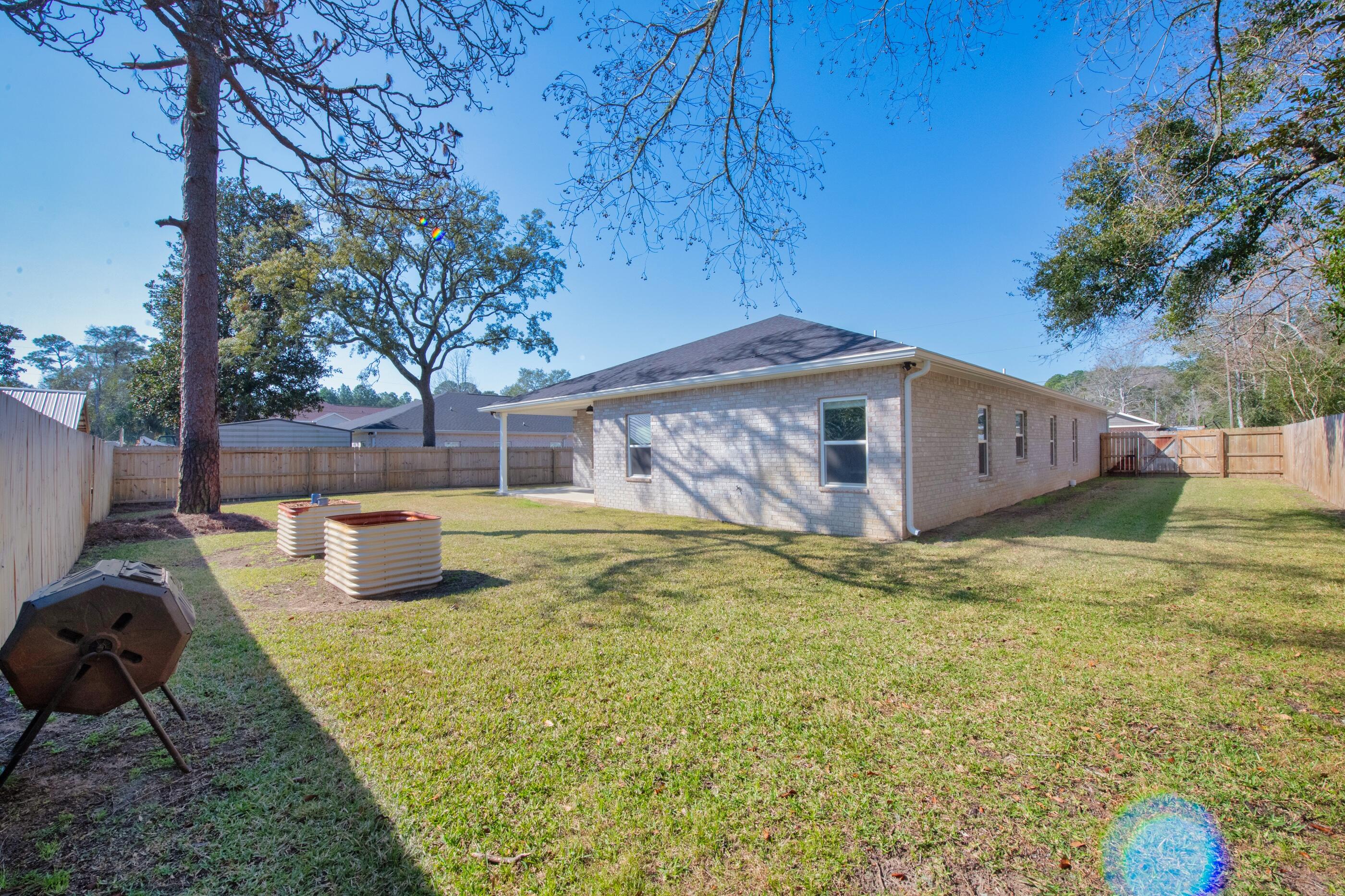 1504 West Ponderosa Road Fort Walton Beach, FL 32547 - Photo 49 of 51 a view of a house with backyard and sitting area
