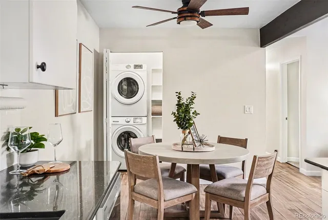 a view of a dining room with furniture and a chandelier