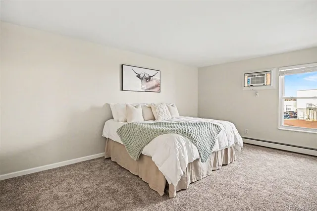 a spacious bedroom with a bed and a window