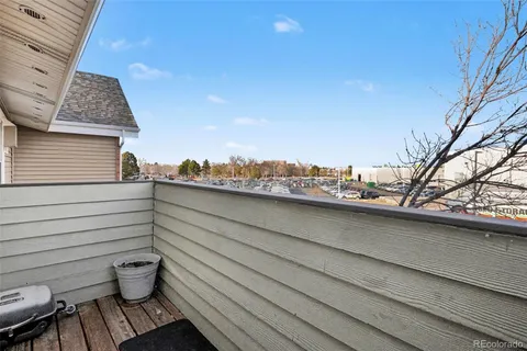 a view of a balcony with chair and potted plants