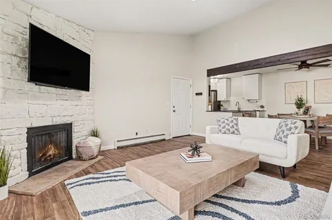 a living room with furniture a fireplace and a flat screen tv