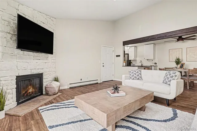 a living room with furniture a fireplace and a flat screen tv