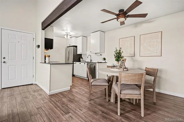 a kitchen with kitchen island white cabinets and stainless steel appliances
