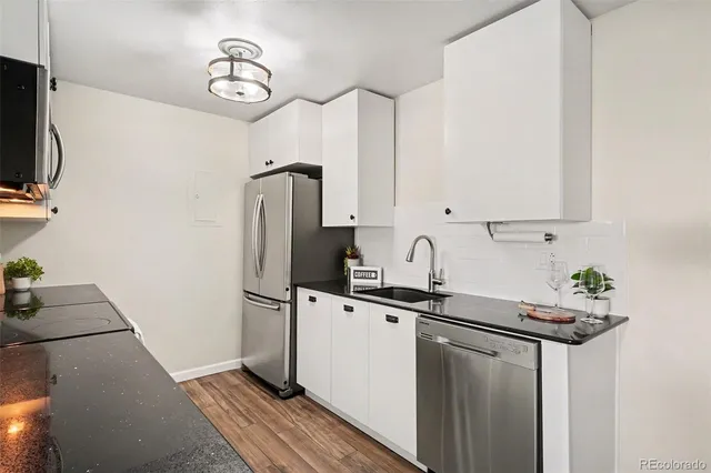 a kitchen with stainless steel appliances a sink stove and refrigerator