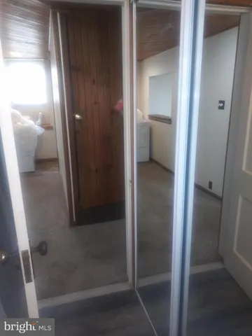 a bathroom with a glass door and mirror