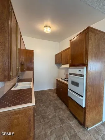 a kitchen with stainless steel appliances granite countertop a refrigerator and a stove