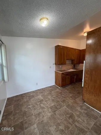 a kitchen with stainless steel appliances a refrigerator and a stove