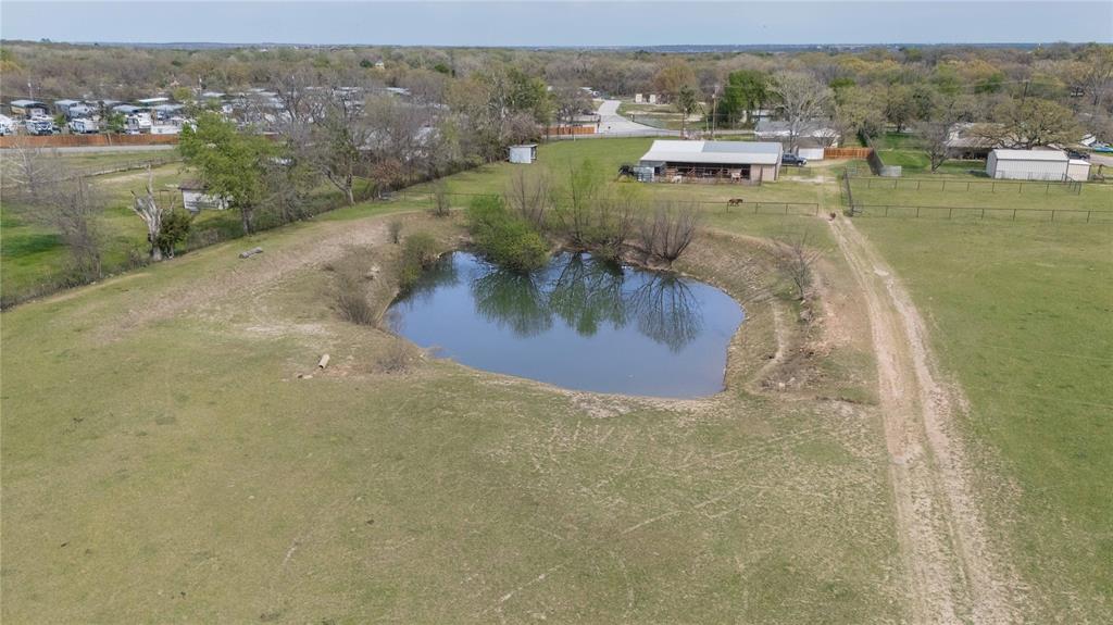 924 Fox Lane Azle, TX 76020 - Photo 7 of 8 Expansive property featuring a private pond surrounded by green pastureland
