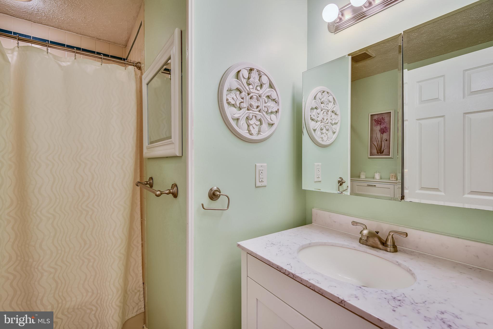 552 Sunset Knoll Road Pasadena, MD 21122 - Photo 21 of 36 a bathroom with a granite countertop sink and a mirror