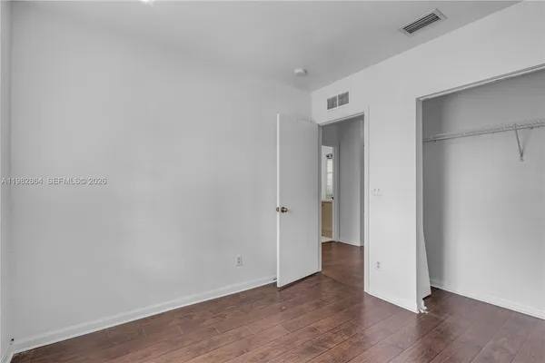 a view of an empty room and wooden floor