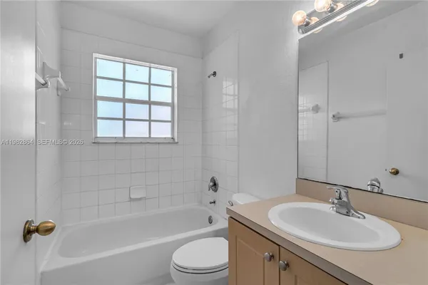 a bathroom with a sink toilet tub and shower