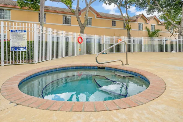 a view of a swimming pool with a house in the background