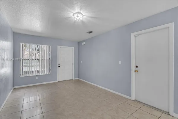a view of an empty room with a window
