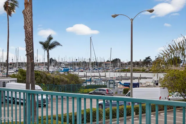 a view of a ocean view with boat and palm trees