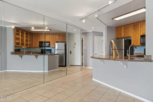 a kitchen with stainless steel appliances granite countertop a refrigerator and a sink