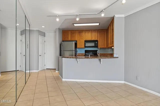 a view of kitchen with stainless steel appliances a refrigerator and a counter top space