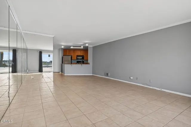 a view of empty room with wooden floor and fireplace