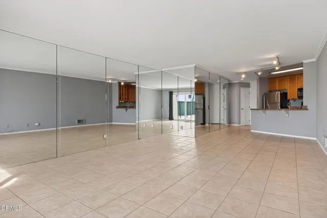a view of an empty room with glass door
