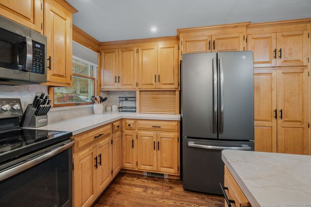a kitchen with stainless steel appliances a refrigerator sink and microwave