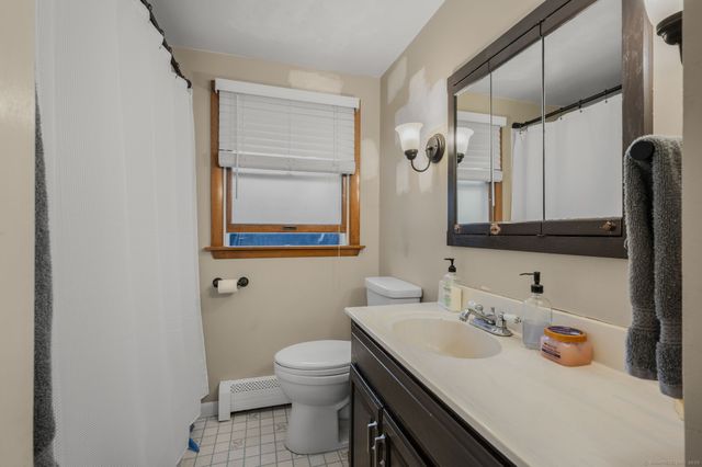 a bathroom with a sink toilet and mirror