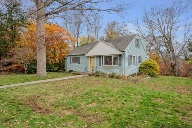 a house with huge green field in front of it