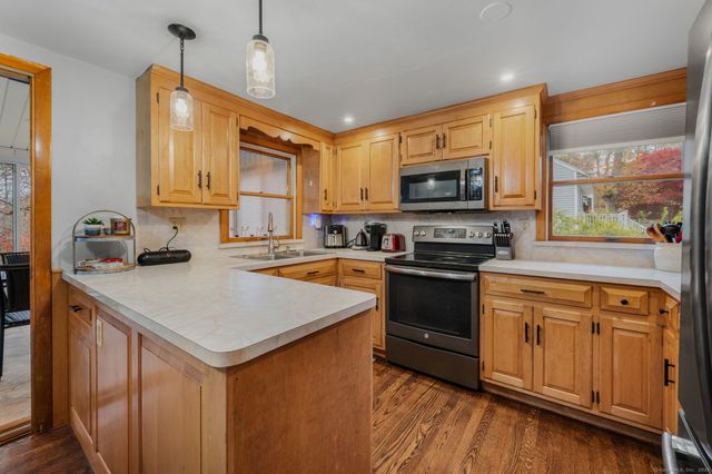 a kitchen with a stove a sink and a microwave